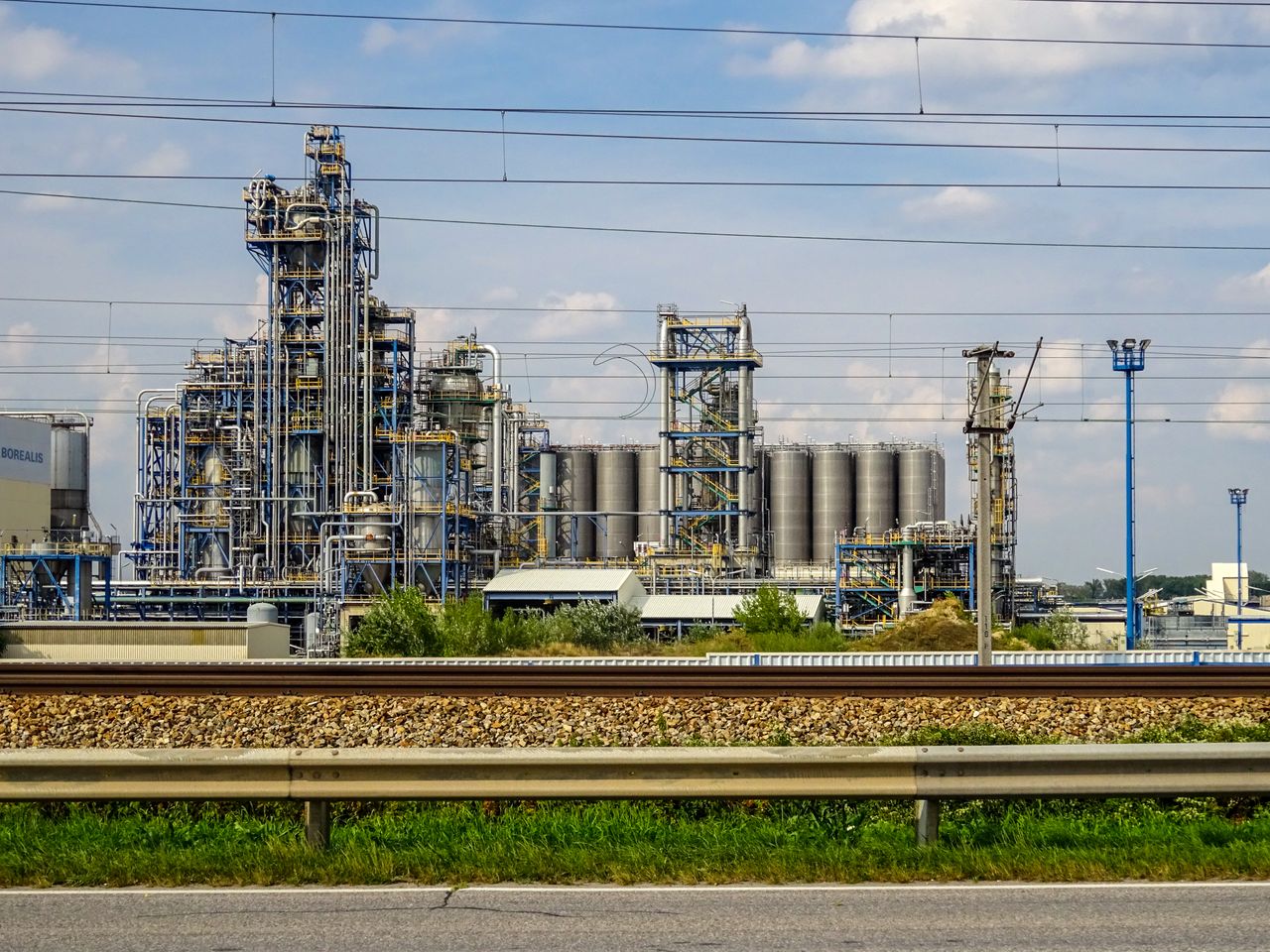 About Image of a large chemical factory in Schwechat, Austria, showcasing industrial pipes and machinery.